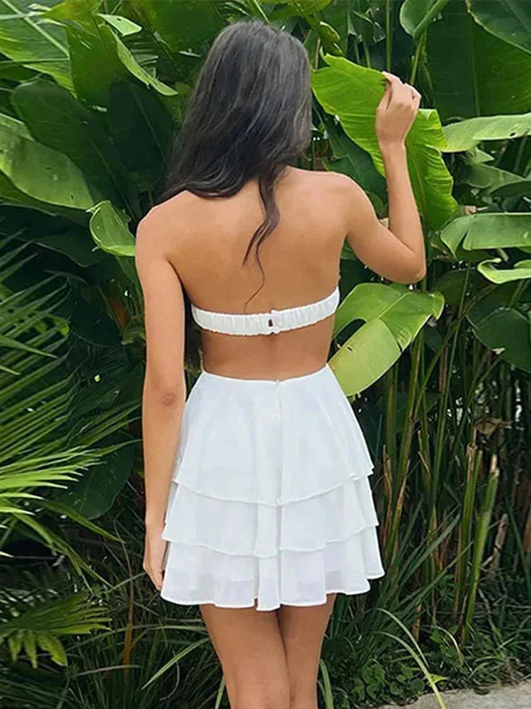 White - Strapless white mini dress featuring an oversized 3D floral bodice, waist cutouts, and a tiered ruffle skirt.