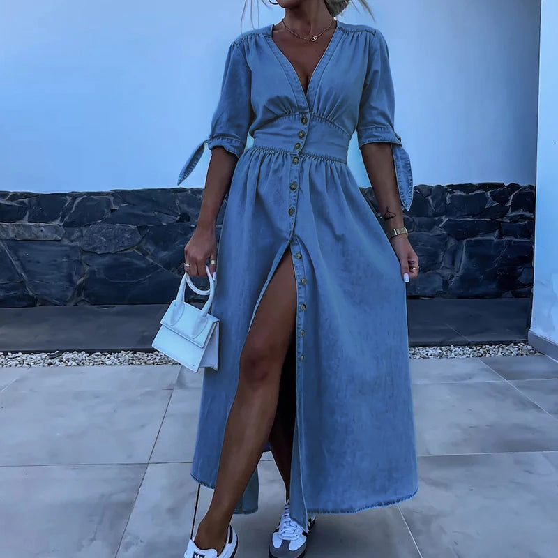 Blue - Light blue denim A-line maxi dress featuring a plunging V-neckline, button-front closure, banded waist, and short sleeves with tie cuffs.