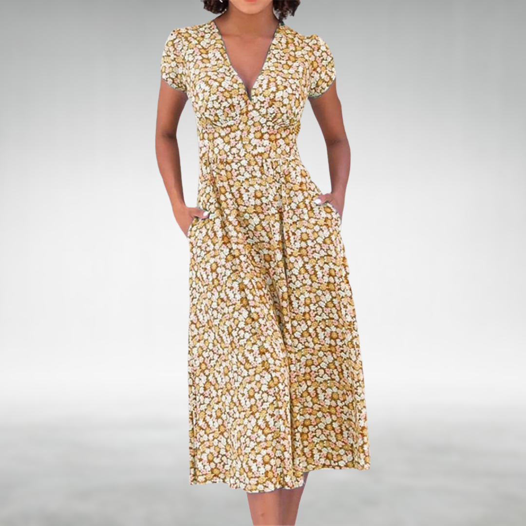 Yellow - A woman wearing a blue and white ditsy floral print midi dress featuring a V-neckline, short cap sleeves, and side pockets, set against a neutral gray background.