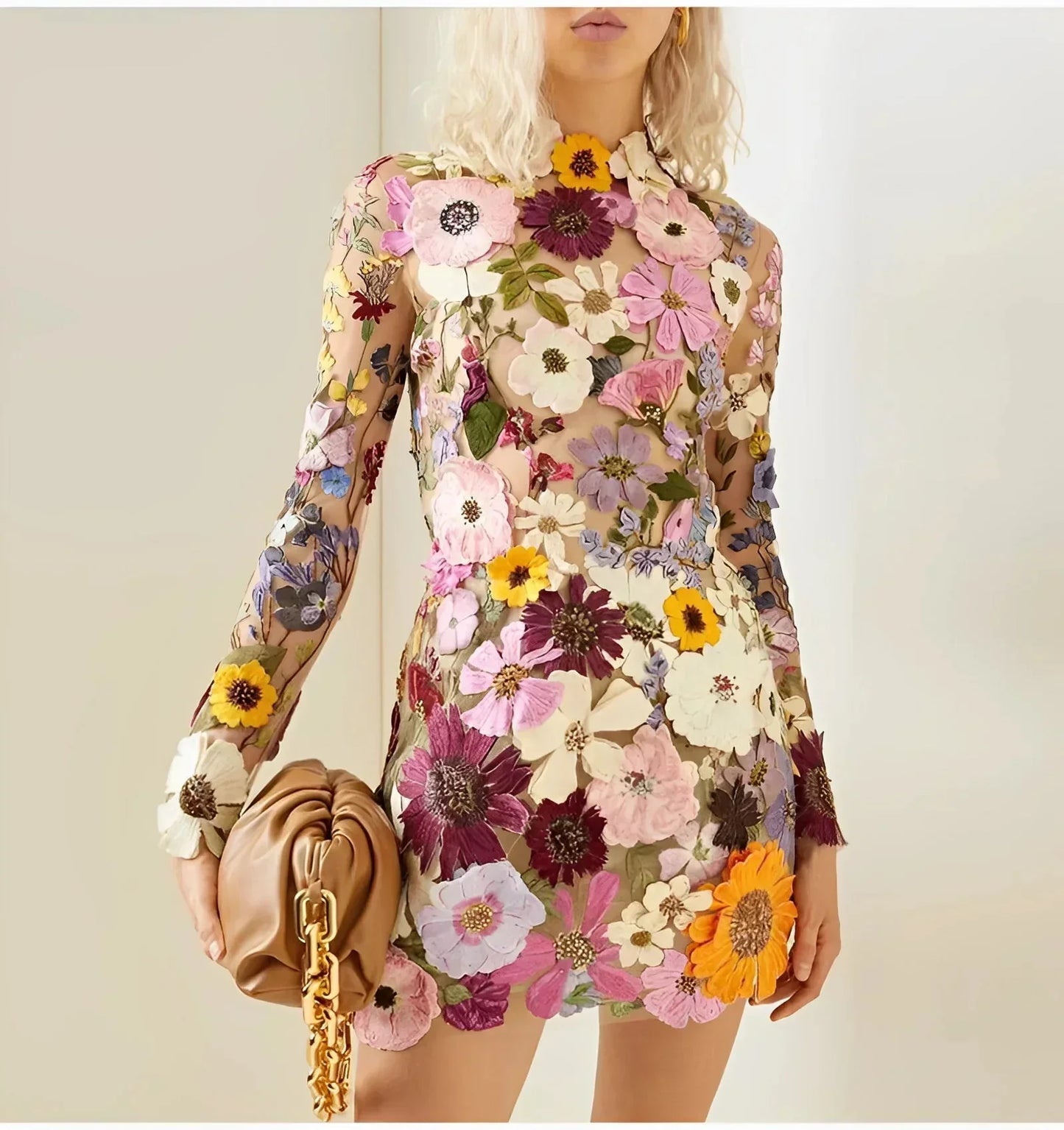 Sheer long-sleeve mini dress featuring a high neckline and dense, multi-colored 3D floral appliqués over a neutral tulle base.