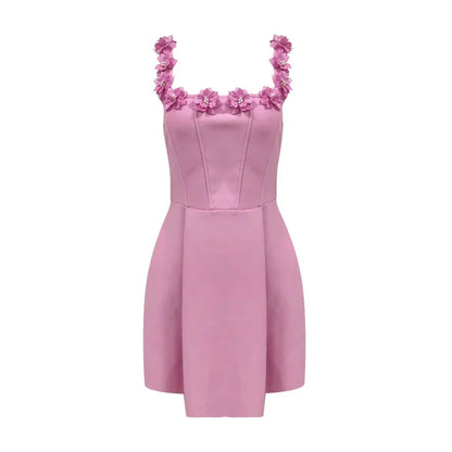 Pink - Sleeveless structured pink mini dress featuring a square neckline adorned with 3D floral appliqués, a tailored bodice with vertical seams, and a pleated A-line skirt with side pockets.