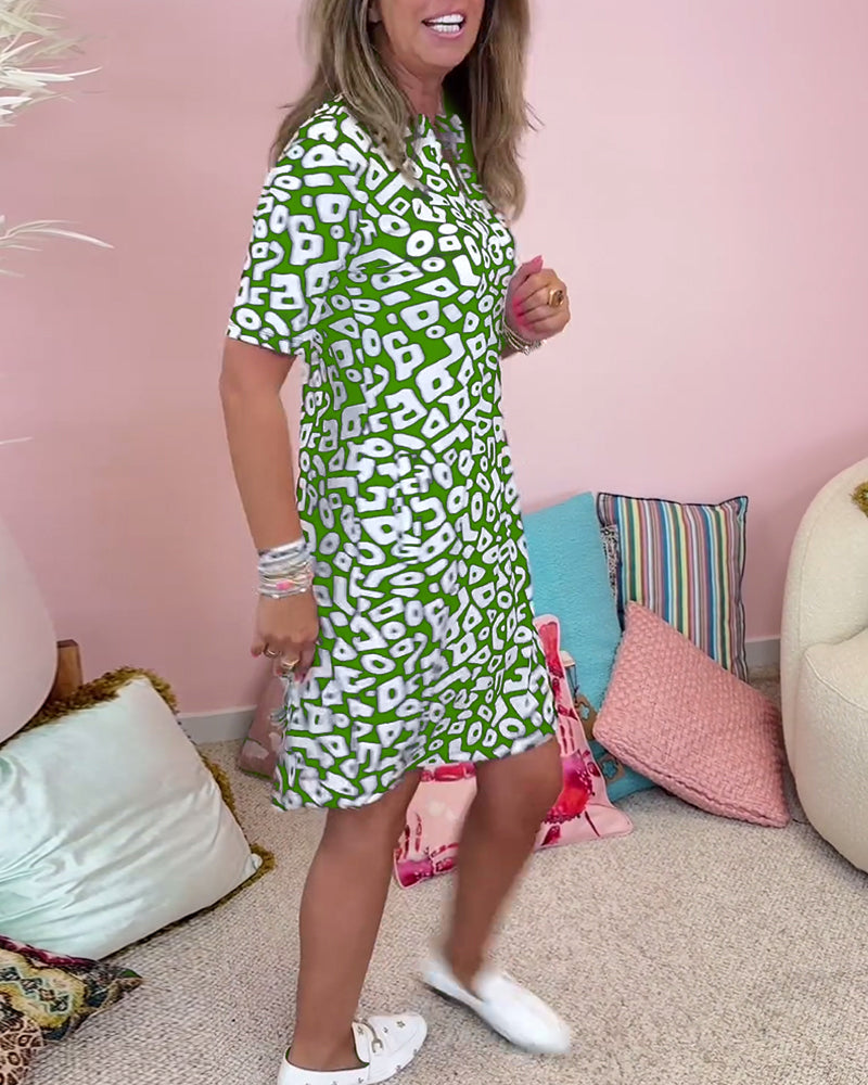 Green - A woman wearing a black and white abstract geometric print shift dress with short sleeves, a split neckline, and side pockets.