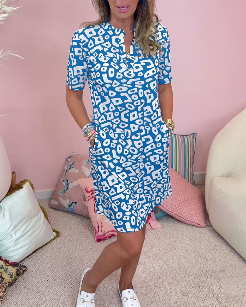 Blue - A woman wearing a black and white abstract geometric print shift dress with short sleeves, a split neckline, and side pockets.
