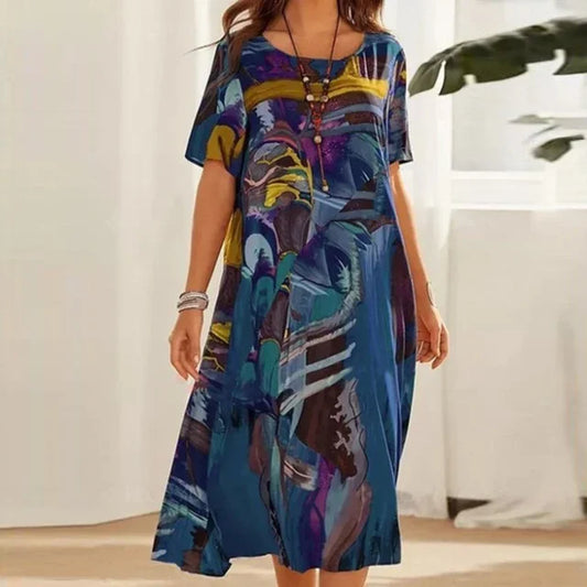 Blue - Women's relaxed fit short sleeve midi dress featuring an abstract painterly print in shades of blue, purple, and yellow.