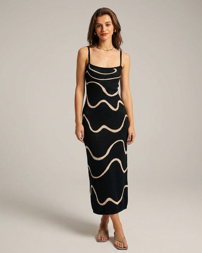 Black - A woman wearing a black knit midi dress featuring a cream abstract wave pattern, thin spaghetti straps, and a square neckline.