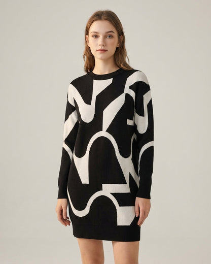 Black - A woman wearing a black knit midi dress featuring a cream abstract wave pattern, thin spaghetti straps, and a square neckline.