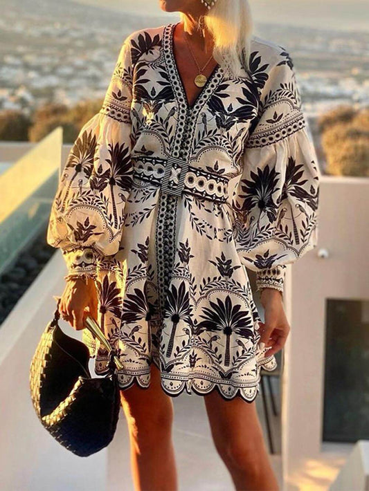 Black - Women's botanical print mini dress featuring voluminous balloon sleeves, a matching structured belt, deep V-neckline, and a scalloped hem.