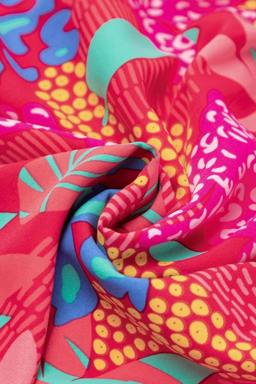 rose - Woman wearing a bright pink abstract botanical print mini dress with a v-neckline, long balloon sleeves, and a tiered babydoll skirt.