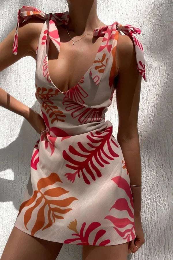 Red floral - Sleeveless linen mini dress with a large-scale red and orange botanical print, featuring a V-neckline and tie-shoulder straps.
