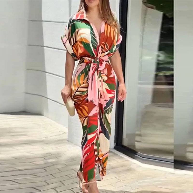 Multi-colour - A woman wearing a green and cream botanical print midi shirt dress with a button-down front, belted waist, and draped skirt detail.
