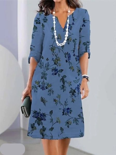 Navy Blue - A woman wearing a slate blue knee-length shift dress with a dark blue botanical floral print, featuring a split neckline, three-quarter sleeves, and a relaxed straight fit.