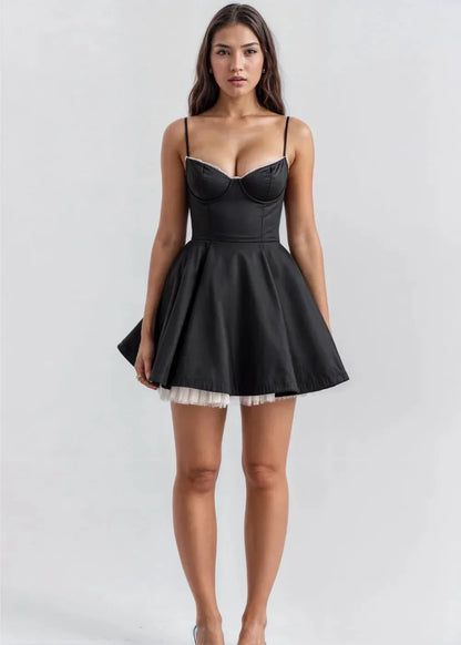 Black - Light pink fit-and-flare mini dress featuring a structured bustier bodice with lace trim, spaghetti straps, and a voluminous skirt with a visible tulle hem underlay.