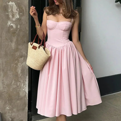 Hue - Midi dress featuring a structured bustier bodice, delicate spaghetti straps, a dropped basque waistline, and a full gathered skirt.