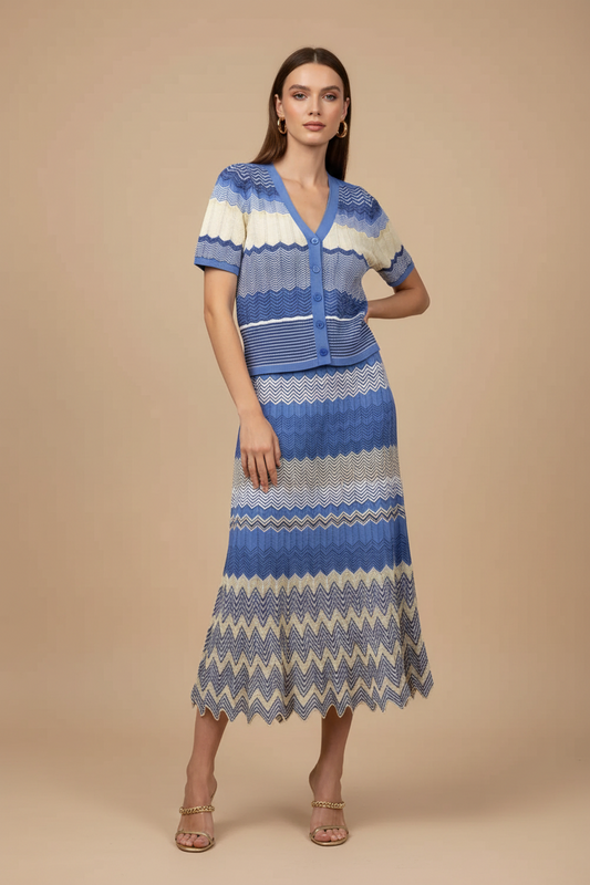 Blue - A woman wearing a blue and cream chevron knit two-piece set featuring a short-sleeve button-front cardigan and a matching A-line midi skirt with a scalloped hem.