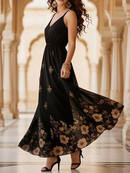 Black - Woman walking in a long, flowy, sleeveless maxi dress featuring a botanical floral pattern and spaghetti straps.