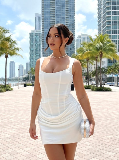White - Dark brown crepe mini dress featuring a structured corset bodice with vertical seaming and a draped, ruched skirt.
