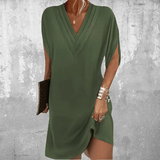Solid green crepe shift dress featuring a deep pleated V-neckline and relaxed split short sleeves.
