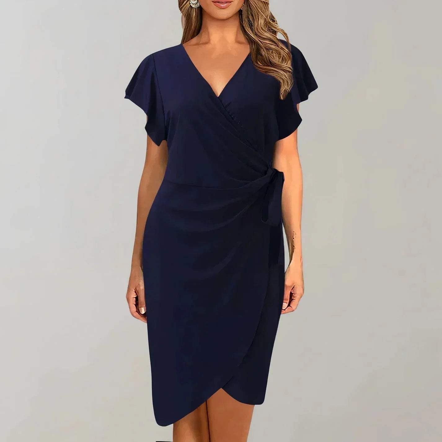 Navy blue - Solid red crepe midi dress featuring a surplice V-neckline, short flutter sleeves, a ruched side tie waist, and an asymmetrical tulip hem.