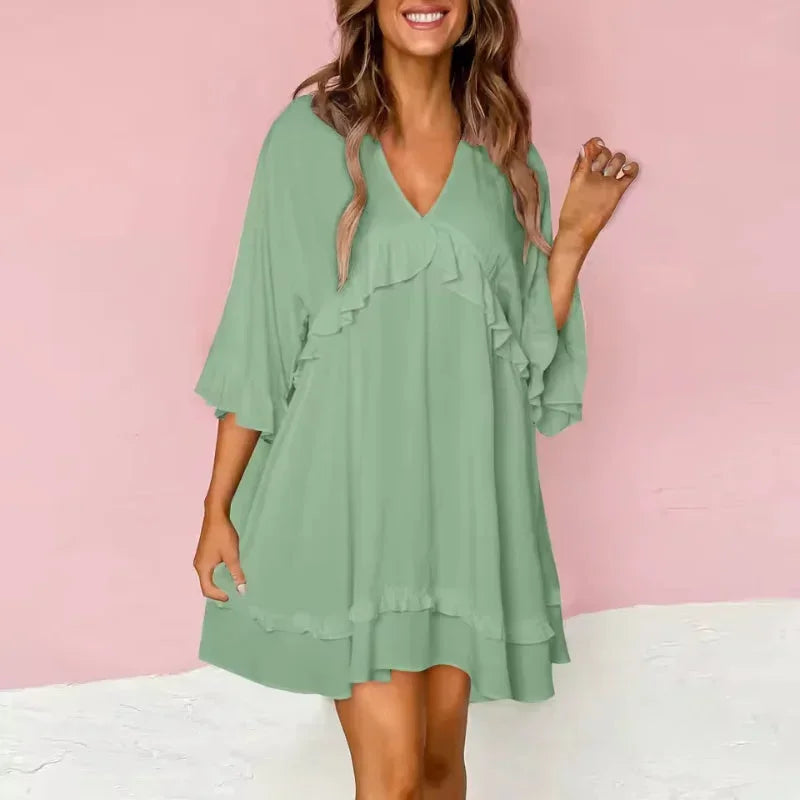 Green - Black crepe swing mini dress featuring a V-neckline, half flutter sleeves, and ruffle trim detailing across the bodice and hem.