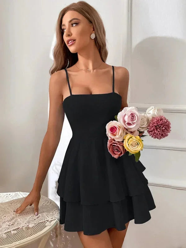 Black - White crepe mini dress featuring a square neckline, thin spaghetti straps, a fitted bodice, and a two-tiered fit-and-flare skirt.