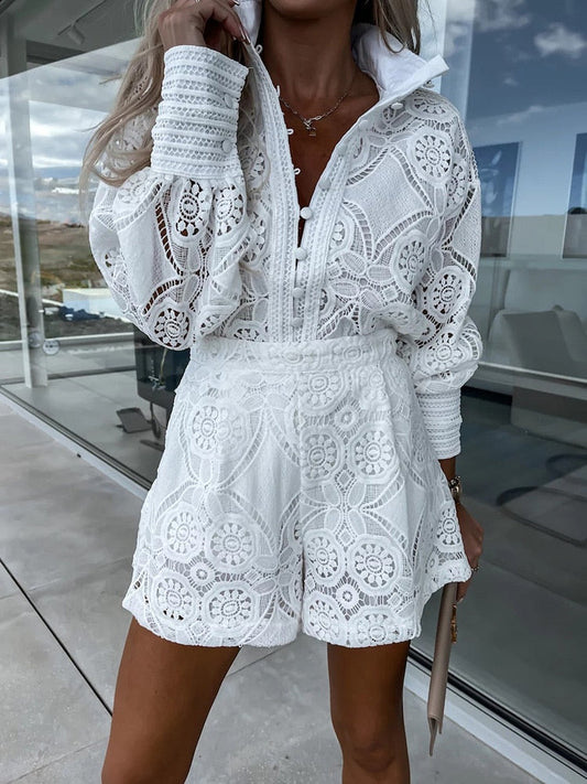 White - White large-scale medallion crochet romper with long balloon sleeves, pointed collar, fabric-covered button placket, and high-waisted relaxed shorts.