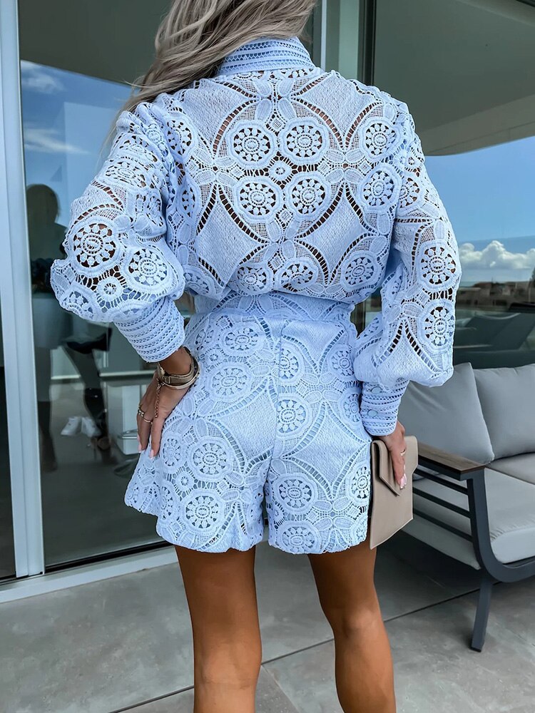 Light Blue - White large-scale medallion crochet romper with long balloon sleeves, pointed collar, fabric-covered button placket, and high-waisted relaxed shorts.