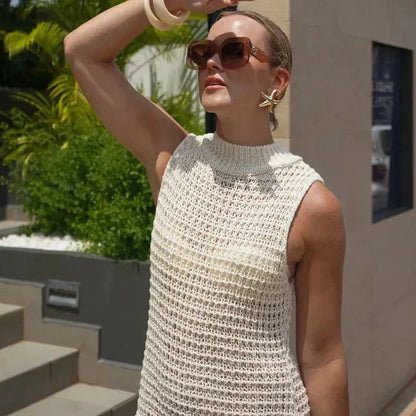 sand - Sleeveless crochet mini dress featuring a high mock neckline and a textured fringed hem.