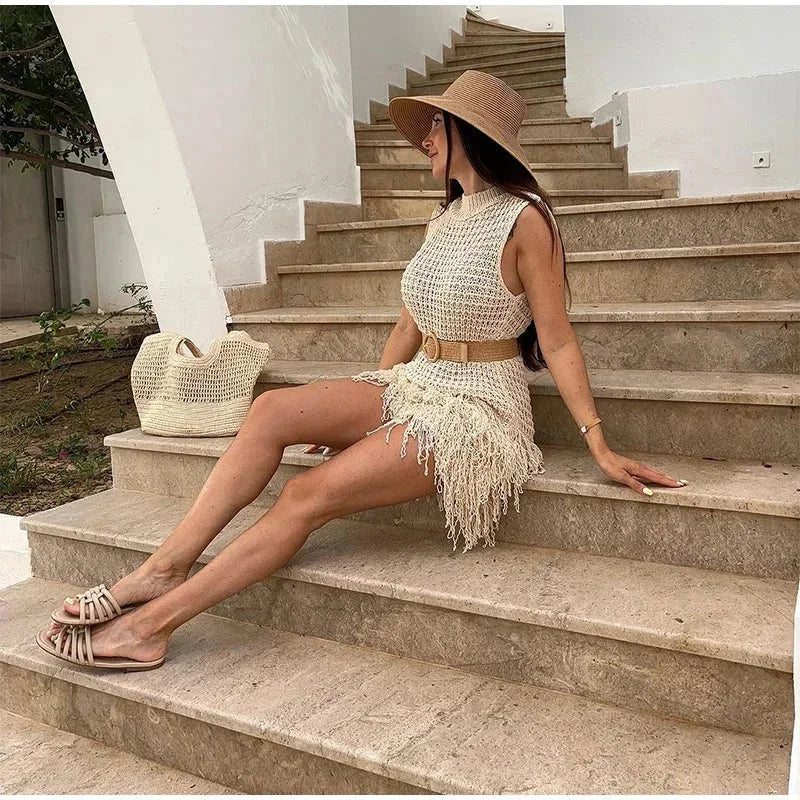 sand - Sleeveless crochet mini dress featuring a high mock neckline and a textured fringed hem.