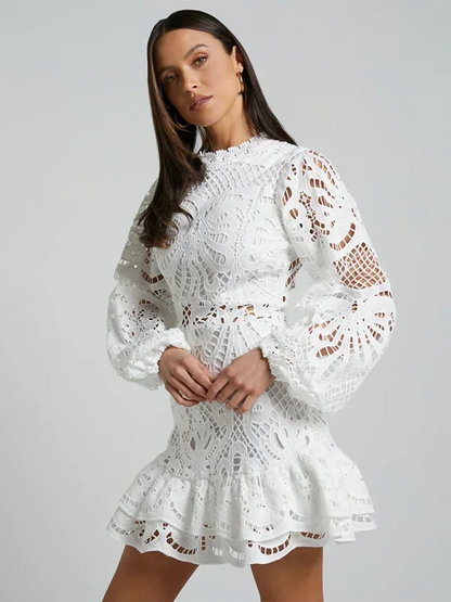 White - Red crochet lace mini dress with high neckline, long bell sleeves, waist cutouts, and a tiered ruffle skirt.