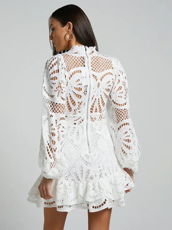 White - Red crochet lace mini dress with high neckline, long bell sleeves, waist cutouts, and a tiered ruffle skirt.