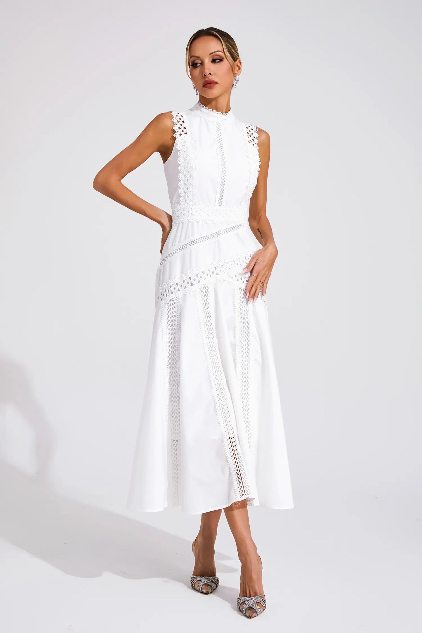 White - Yellow sleeveless midi dress featuring a high neckline, intricate crochet lace paneling, and a flowing A-line skirt with vertical lace inserts.