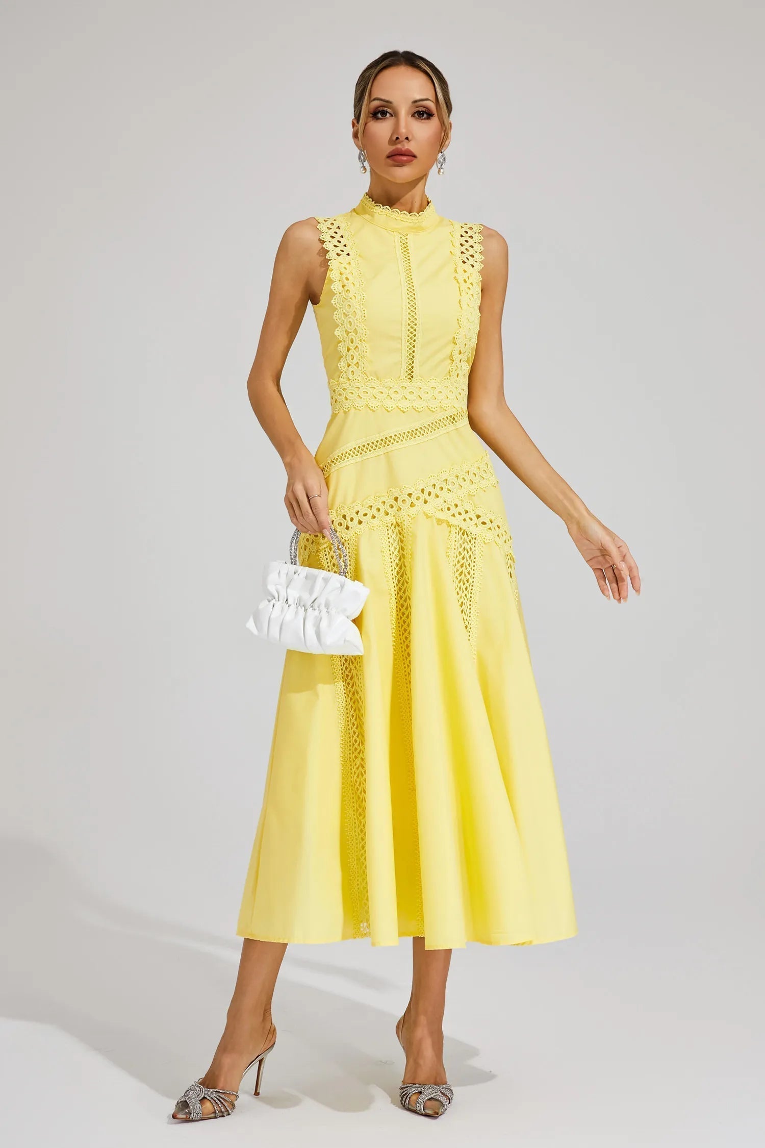 Blue - Yellow sleeveless midi dress featuring a high neckline, intricate crochet lace paneling, and a flowing A-line skirt with vertical lace inserts.