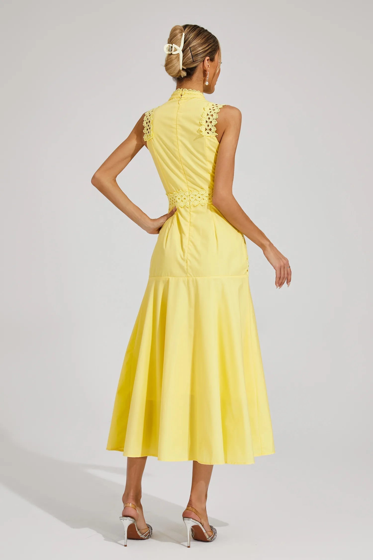 Blue - Yellow sleeveless midi dress featuring a high neckline, intricate crochet lace paneling, and a flowing A-line skirt with vertical lace inserts.