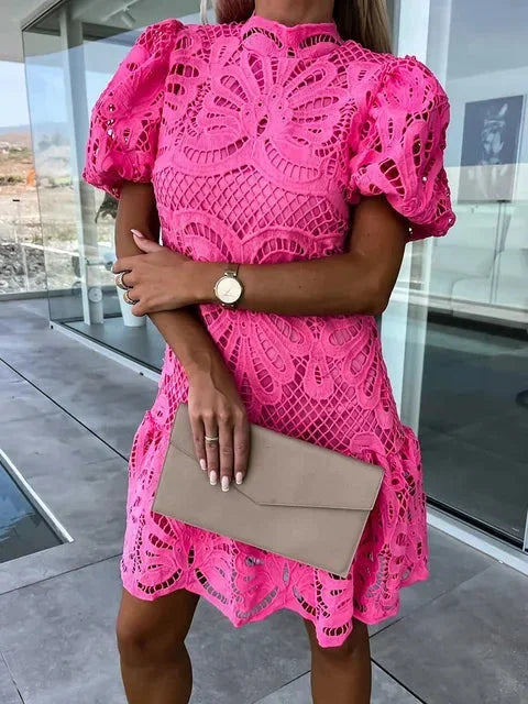 Pink - Bright pink heavy floral crochet mini dress featuring short puff sleeves, a high mock neckline, and a flared drop-waist silhouette.