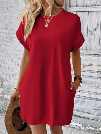 Solid red short-sleeve shift mini dress featuring a crew neckline, rolled cuffs, and side seam pockets.