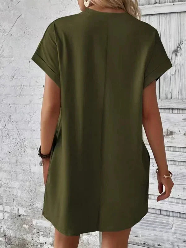 Green - Solid red short-sleeve shift mini dress featuring a crew neckline, rolled cuffs, and side seam pockets.