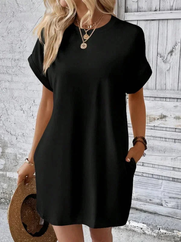 Black - Solid red short-sleeve shift mini dress featuring a crew neckline, rolled cuffs, and side seam pockets.