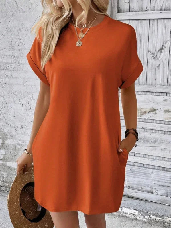 Orange - Solid red short-sleeve shift mini dress featuring a crew neckline, rolled cuffs, and side seam pockets.