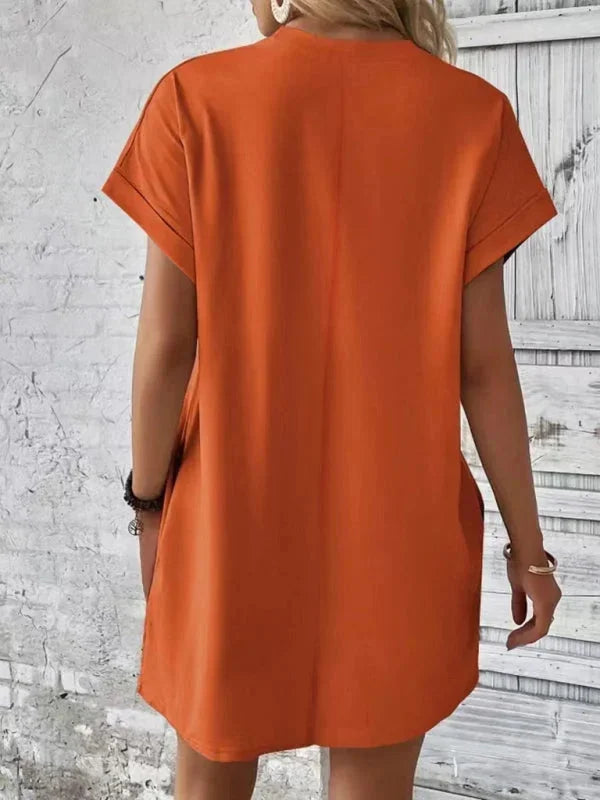 Orange - Solid red short-sleeve shift mini dress featuring a crew neckline, rolled cuffs, and side seam pockets.