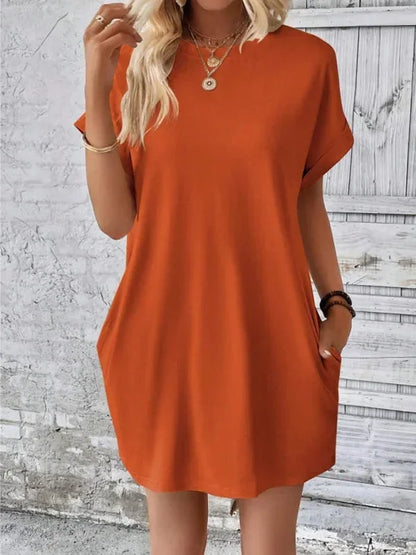 Orange - Solid red short-sleeve shift mini dress featuring a crew neckline, rolled cuffs, and side seam pockets.
