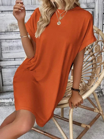 Orange - Solid red short-sleeve shift mini dress featuring a crew neckline, rolled cuffs, and side seam pockets.