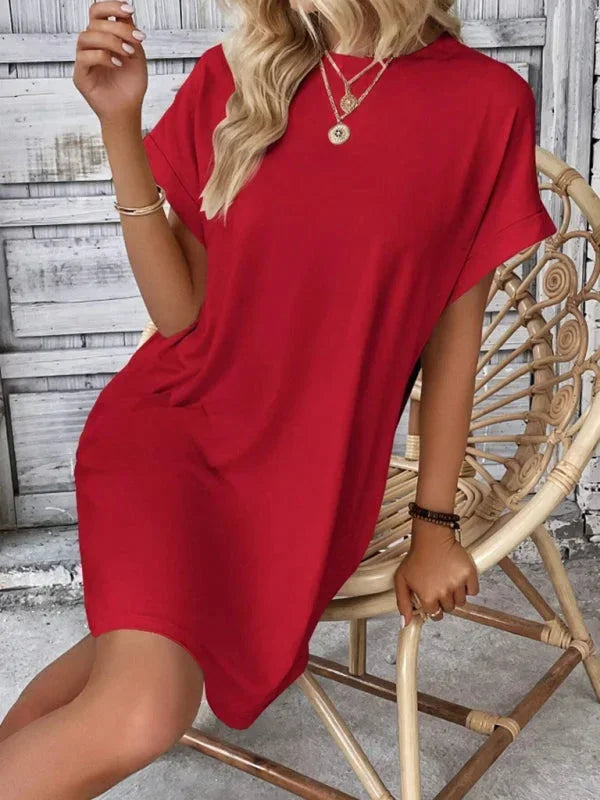 Red - Solid red short-sleeve shift mini dress featuring a crew neckline, rolled cuffs, and side seam pockets.