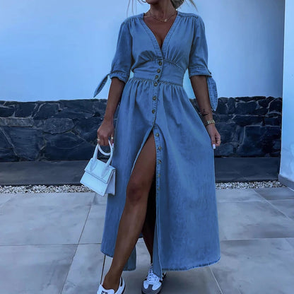 Blue - Light blue denim A-line maxi dress featuring a plunging V-neckline, button-front closure, banded waist, and short sleeves with tie cuffs.