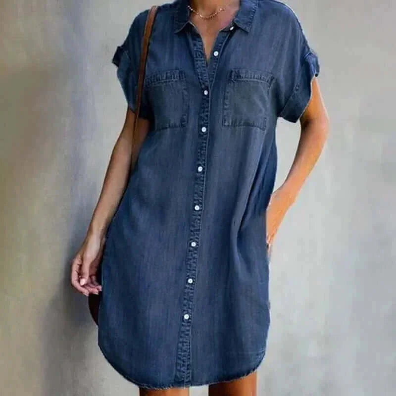 Dark blue - Light wash denim short-sleeve mini shirt dress featuring a collared neckline, button-front closure, dual chest pockets, and a curved hem.