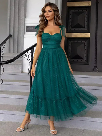 Green - Bright pink dotted tulle midi dress featuring a ruched bustier bodice, adjustable tie shoulder straps, and a voluminous gathered skirt.