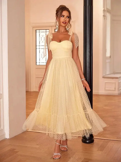 Yellow - Bright pink dotted tulle midi dress featuring a ruched bustier bodice, adjustable tie shoulder straps, and a voluminous gathered skirt.