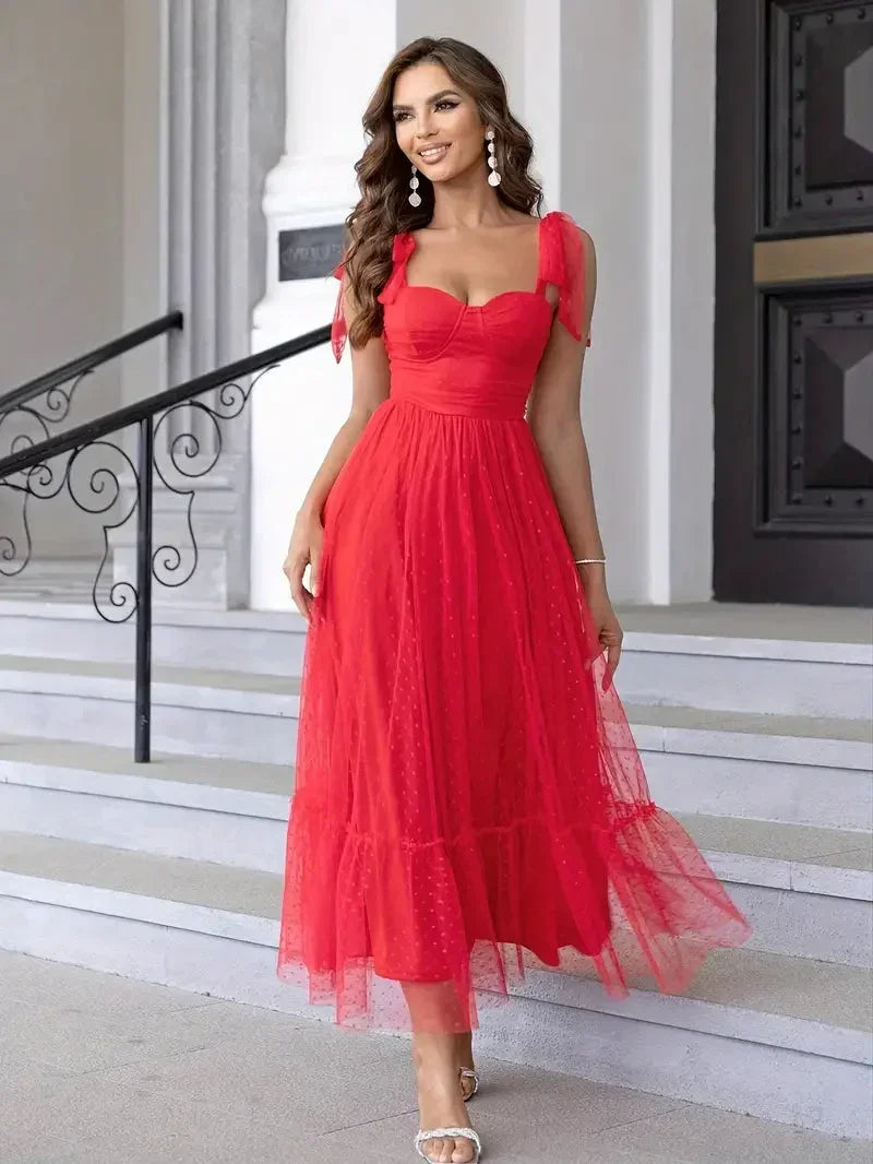 Red - Bright pink dotted tulle midi dress featuring a ruched bustier bodice, adjustable tie shoulder straps, and a voluminous gathered skirt.