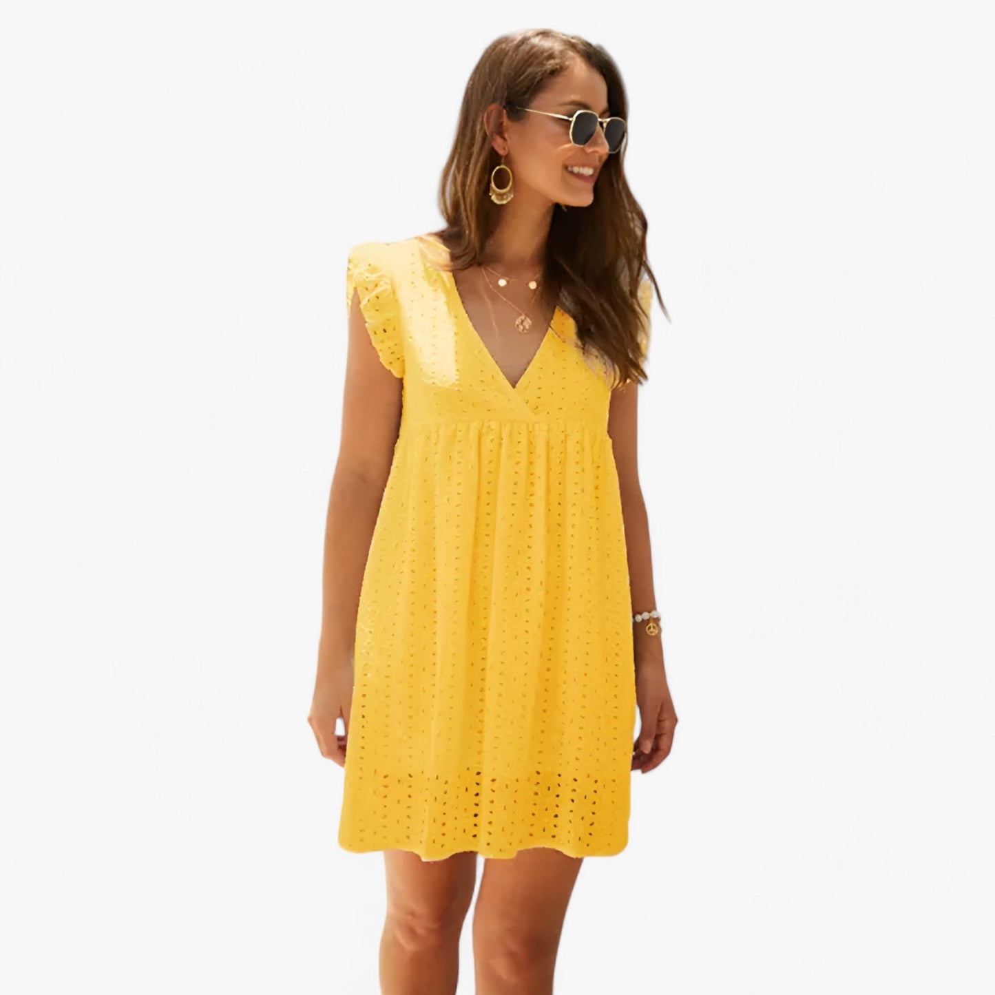 Mustard - A woman smiling in a black eyelet mini dress with flutter sleeves, a deep V-neckline, and an empire waist, set against a clean white background.