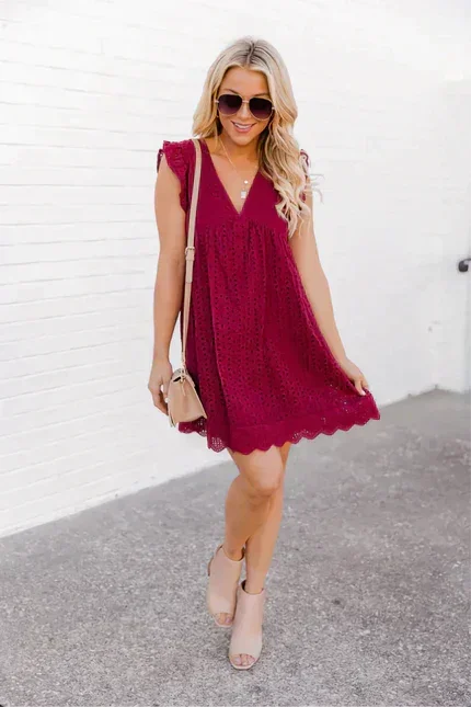 Rose Red - White eyelet mini dress featuring a V-neckline, ruffle flutter sleeves, and a scalloped hem.