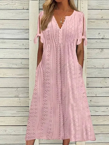PINK - A woman wearing a light blue midi-length eyelet dress with a scalloped V-neckline, split tie-sleeves, and side pockets, shown alongside color variations in pink, white, and mint green.